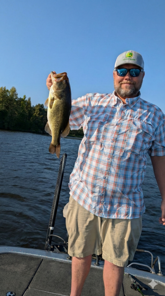 Chad-Pafford Holding Large Bass Fish While Fishing on Lake